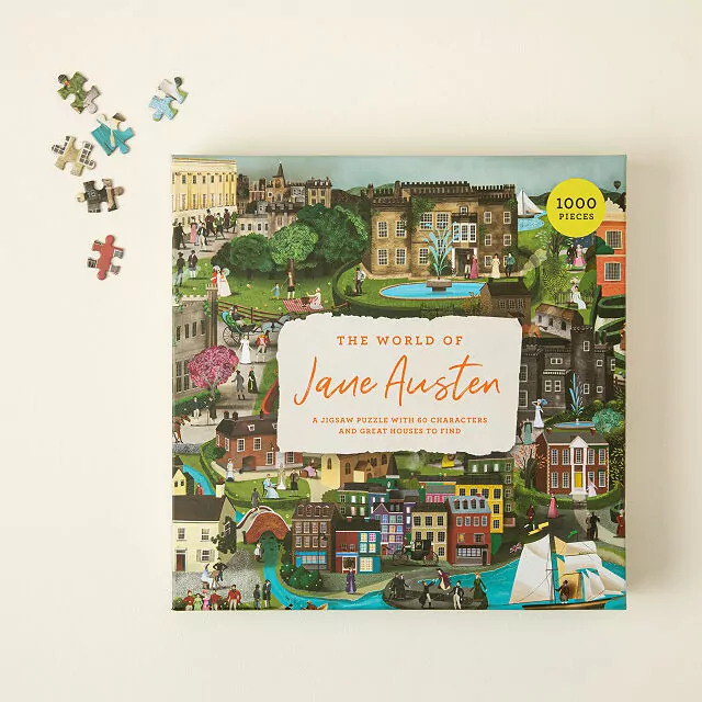 Box of a 1000-piece puzzle titled "The World of Jane Austen." The cover features an intricate illustration of a vibrant village scene. The background is beige with six puzzle pieces on it.