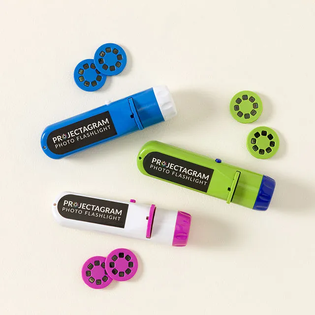 A blue flashlight, a green flashlight, and a white flashlight