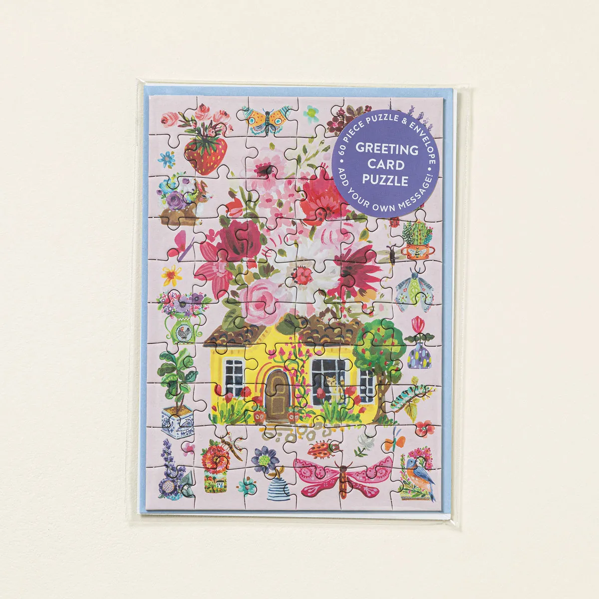 Floral Cottage Puzzle Greeting Card with illustrated cottage, flowers, butterflies, and animals